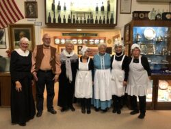 Lyon County Museum Board Members pose briefly before the event: Heather Wharton, Brian Grimere, Ann Davies, Cheryl Hayes, Mary Page, Janice Shipley, and Nancy Pursel.